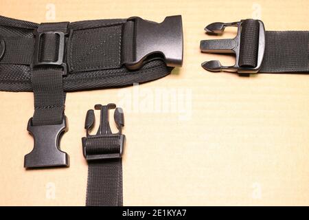 Black plastic buckle fastex for backpacks. Accessories for backpacks, fastener close-up. Stock Photo
