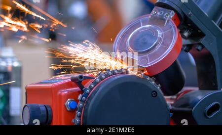 Automatic saw chain sharpening machine during work at workshop - close up Stock Photo