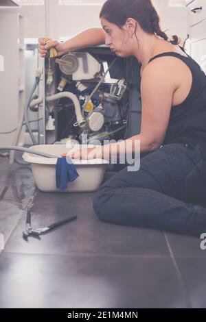 Woman needs a plumber to repair the leak Stock Photo - Alamy