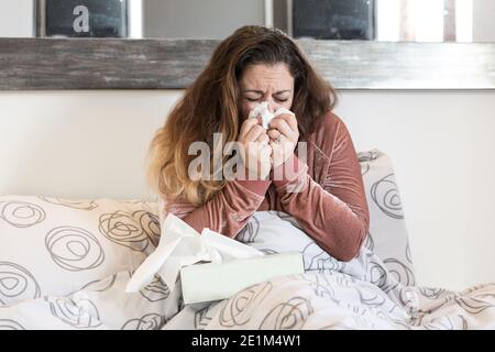 sick woman , flu or covid19 desease, cold and she has fever