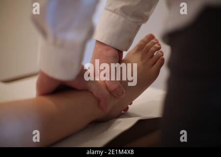 Osteopath manipulating a woman patient Stock Photo