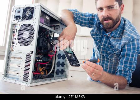Engineer repairs computer's hard drive Stock Photo