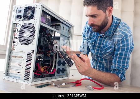 Engineer repairs computer's hard drive Stock Photo