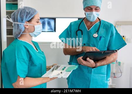 Surgeon and nurse prepare for surgery Stock Photo