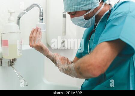 Surgeon or nurse washing hands before surgical intervention Stock Photo