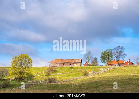 Farmhouse on a hill in a rural landscape Stock Photo