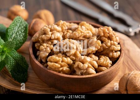 Walnuts in a wooden bowl. Shelled walnuts. Healthy organic nuts Stock Photo