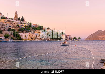 Sunset over the Harani area of Gialos Town, Symi Island, Greece Stock Photo