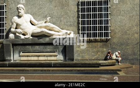 Couple sat next to Fountain of the River Po Statue in Piazza CLN behind San Carlo Church, Turin, Piedmont, Italy Stock Photo
