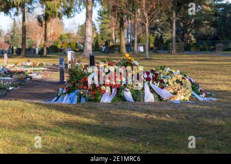 Fresh earth grave in a cemetery Stock Photo