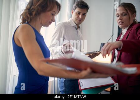 Group of colleagues preparing paperwork for a meeting together Stock Photo
