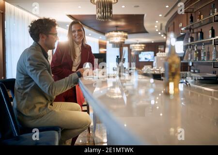 Two young colleagues chatting and socializing on a coffee break Stock Photo