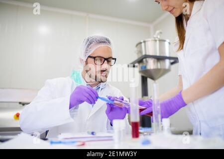 Lab employee working on some product tests. Stock Photo