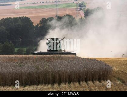 Head-on view of a John Deere combine harvester working in a field in Eisenach, Germany Stock Photo