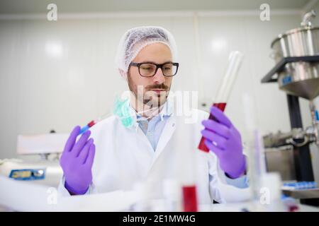 Lab employee working on some product tests. Stock Photo