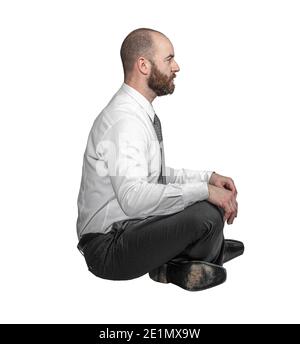 businessman in cross-legged position sitting side view isolated on white. Stock Photo