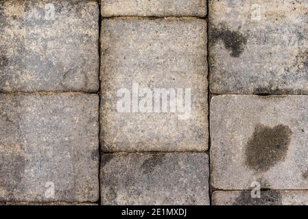 Oil stained cobblestones, rock structure and cubes close up. Stock Photo