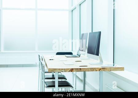 desktop with laptop and computers in an empty office. Stock Photo