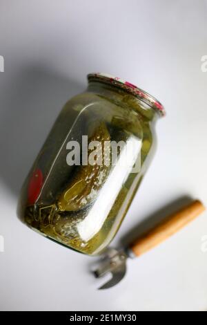 jar of homemade marinated pickles with a bottle opener Stock Photo