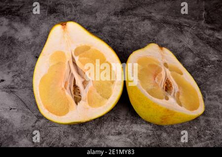 Cut in half the pomelo fruit on a dark background Stock Photo