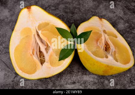 Cut in half the pomelo fruit on a dark background Stock Photo