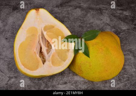 Cut in half the pomelo fruit on a dark background Stock Photo