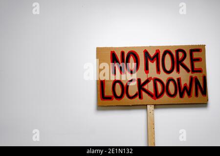 Protestive placard against coronavirus lockdowns against wall Stock Photo