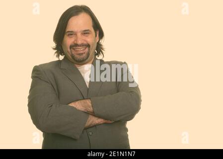 Happy fat Caucasian businessman smiling with arms crossed Stock Photo