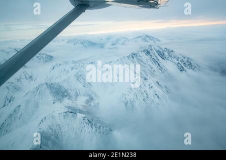 Flying over Brooks Mountain Range in the Arctic Circle on the way to Kaktovik Stock Photo
