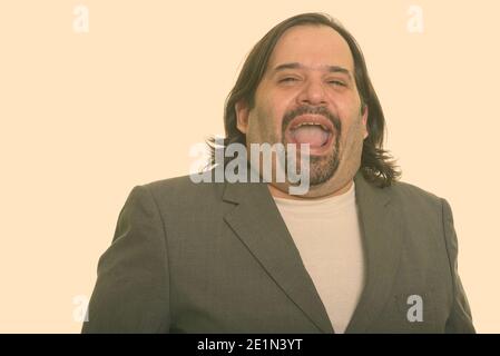 Happy fat Caucasian businessman smiling and laughing Stock Photo