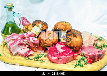 fillet of beef, chicken, ribs and sausages, ready for your barbeque and for your lunch, freshly prepared by the butcher and porcini mushrooms Stock Photo