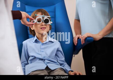 Frustrated boy cannot see the letters on a chart Stock Photo