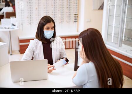 Determined physician encouraging her customer for buying a package