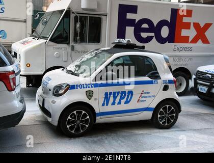 New York Street Scene with Mini NYPD Car and Fed Ex Van Stock Photo