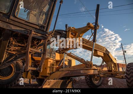 A road grader in the morning sun. Stock Photo