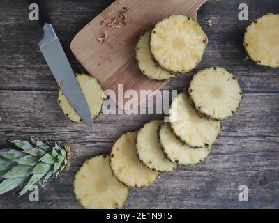 Sliced and chopped pineapple on a dark background Stock Photo