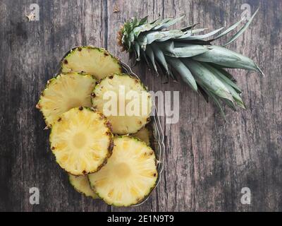 Sliced and chopped pineapple on a dark background Stock Photo