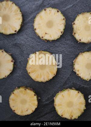 Sliced and chopped pineapple on a dark background Stock Photo