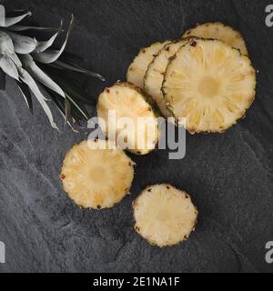 Sliced and chopped pineapple on a dark background Stock Photo