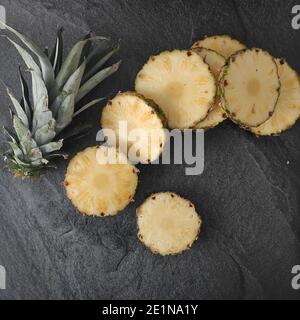 Sliced and chopped pineapple on a dark background Stock Photo