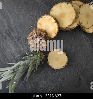 Sliced and chopped pineapple on a dark background Stock Photo