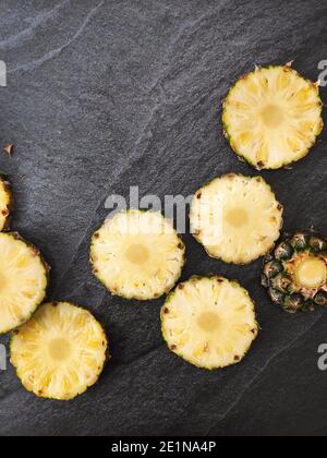 Sliced and chopped pineapple on a dark background Stock Photo