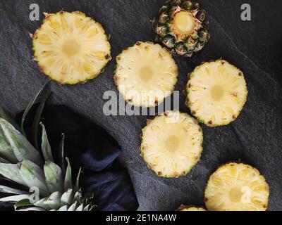 Sliced and chopped pineapple on a dark background Stock Photo
