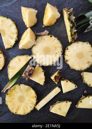 Sliced and chopped pineapple on a dark background Stock Photo