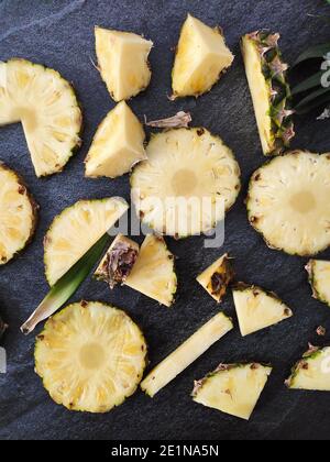 Sliced and chopped pineapple on a dark background Stock Photo
