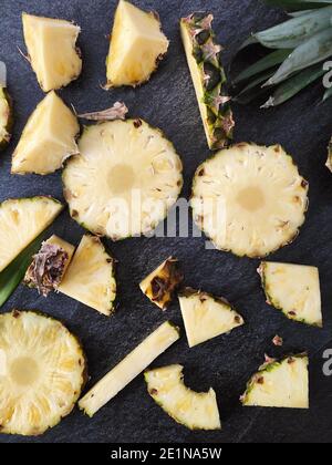 Sliced and chopped pineapple on a dark background Stock Photo