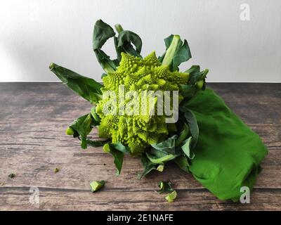 A whole romanesco broccoli on a kitchen table Stock Photo