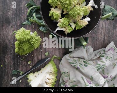 A bowl of broccoli on a table Stock Photo