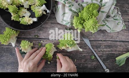 A bowl of broccoli on a table Stock Photo