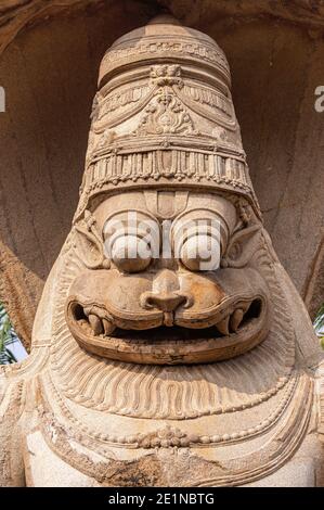 Hampi, Karnataka, India - November 5, 2013: Lakshmi Narasimha Temple. Closeup of brown stone face of the god. Stock Photo